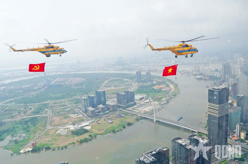 View - 	Helicopters rehearse flag display for national grand event